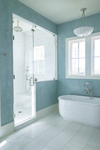 A custom blue Venetian plaster installation done in a primary bathroom in Ravenel, SC. Emily Pope Harris applied this 3 layer application by hand and you can see the movement, depth , texture, and burnish/polish throughout. 