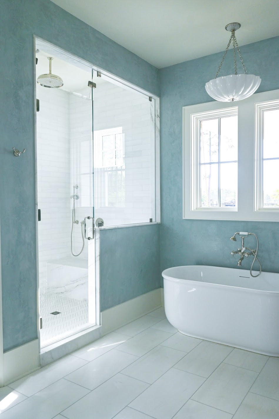A custom blue Venetian plaster installation done in a primary bathroom in Ravenel, SC. Emily Pope Harris applied this 3 layer application by hand and you can see the movement, depth , texture, and burnish/polish throughout. 