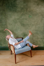 Emily sitting in a chair in front of the plaster work she did in a commercial space at the Refinery in downtown Charleston. She did a layered heavily textured plaster and added a green glaze on top! 
