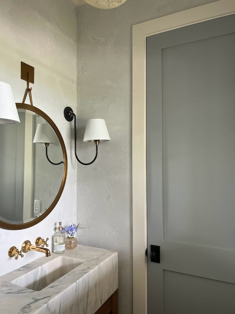 Dusty light blue Venetian plaster in a Daniel Island powder bathroom by Emily Pope Harris, featuring heavy texture and a matte finish, completed with Jackson Built Custom Homes.