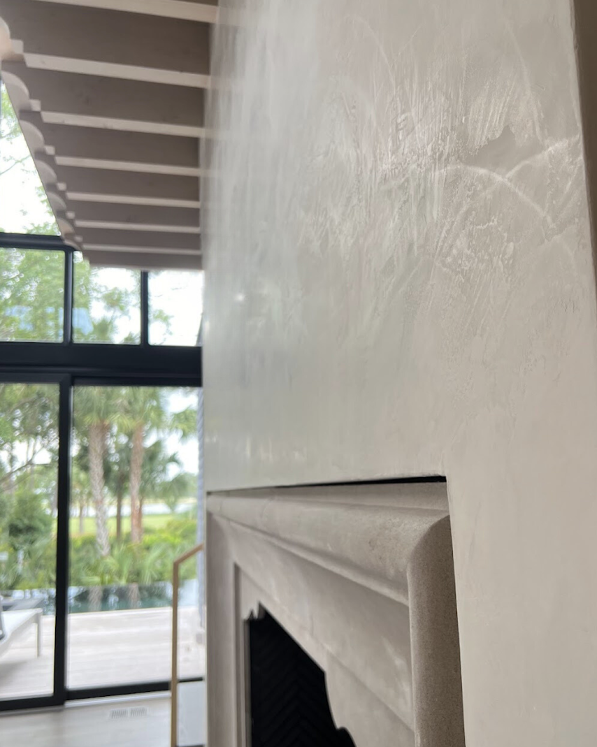 Side and close-up view of Kiawah Island fireplace in Egret White Venetian plaster, showing burnish and subtle movement.