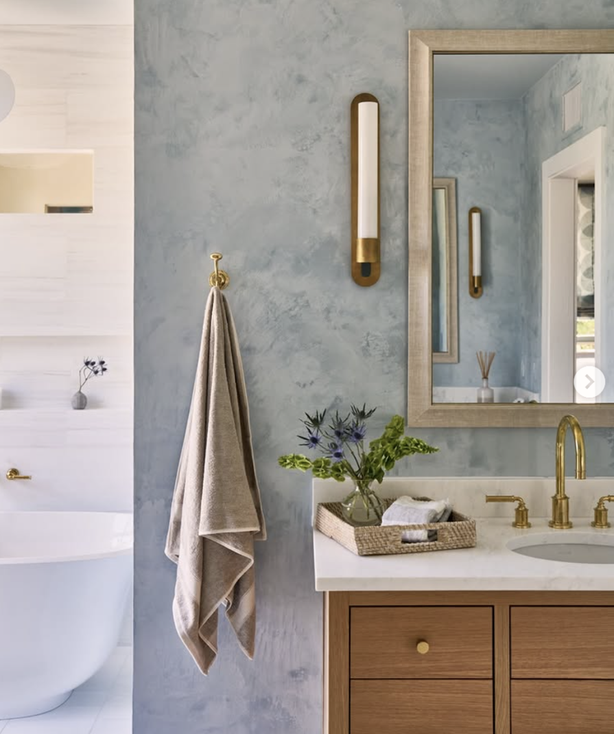 Custom light blue Venetian plaster wall with burnish and polished sheen in a master bathroom at the CSOL Designer Show house in Charleston, SC, designed by PWD Studio.