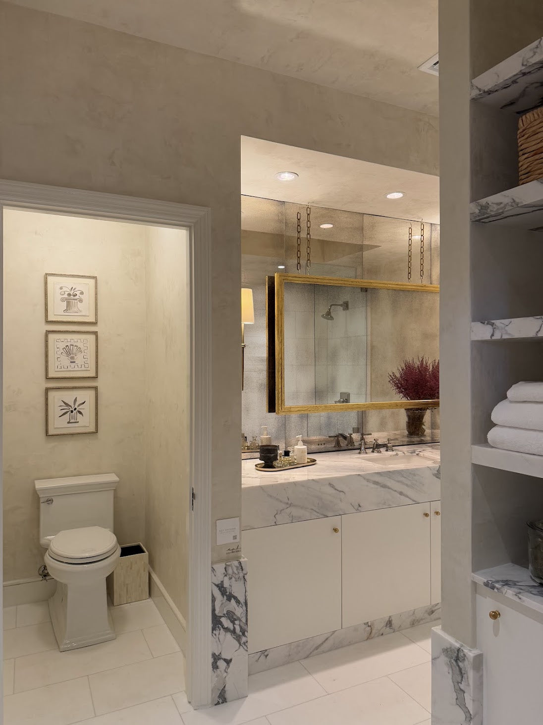 Two-tone cream Venetian plaster installation covering walls and ceiling in the primary bathroom and water closet at the Palm Beach Kips Bay Designer Show House, hand-applied and polished by Emily Pope Harris.